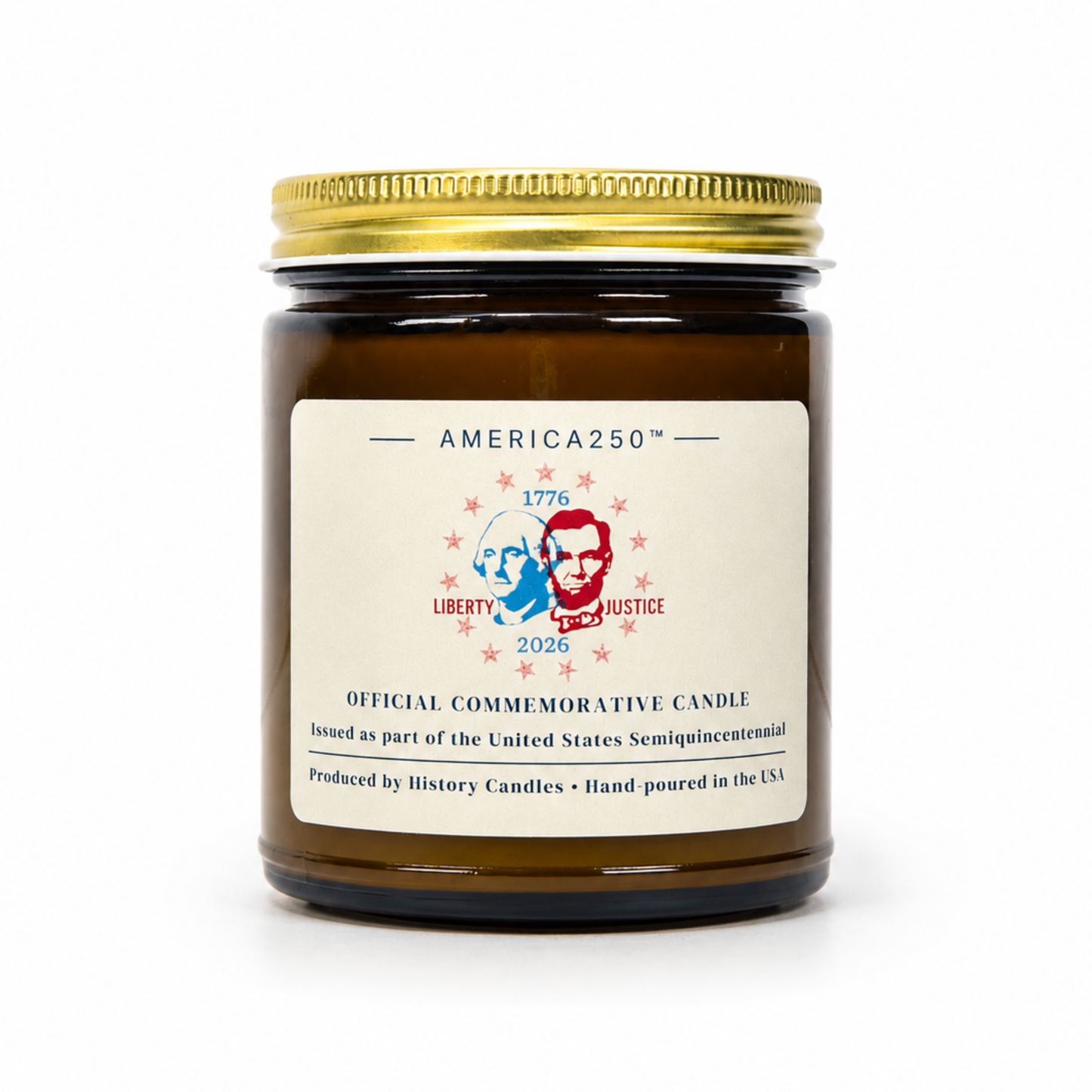 An amber glass jar candle with a gold metal lid and a cream-colored label. The label features the brand name 'AMERICA250' and a commemorative design for 'Liberty and Justice 2026' with portraits of Thomas Jefferson and Abraham Lincoln.
