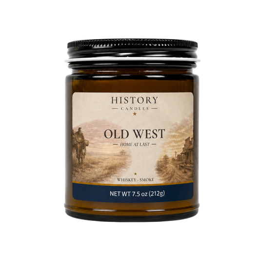 Old West candle in an amber glass jar with black lid, featuring Old West artwork and a Whiskey & Smoke fragrance.