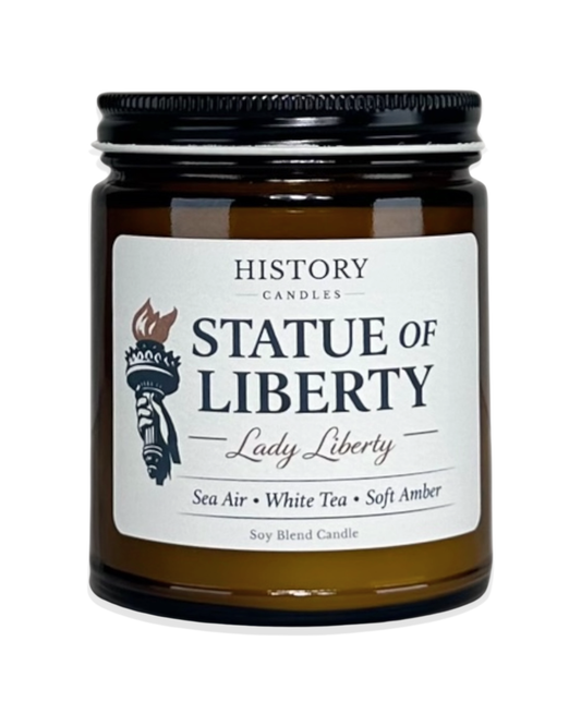 Statue of Liberty soy candle in amber glass jar with black lid on white background