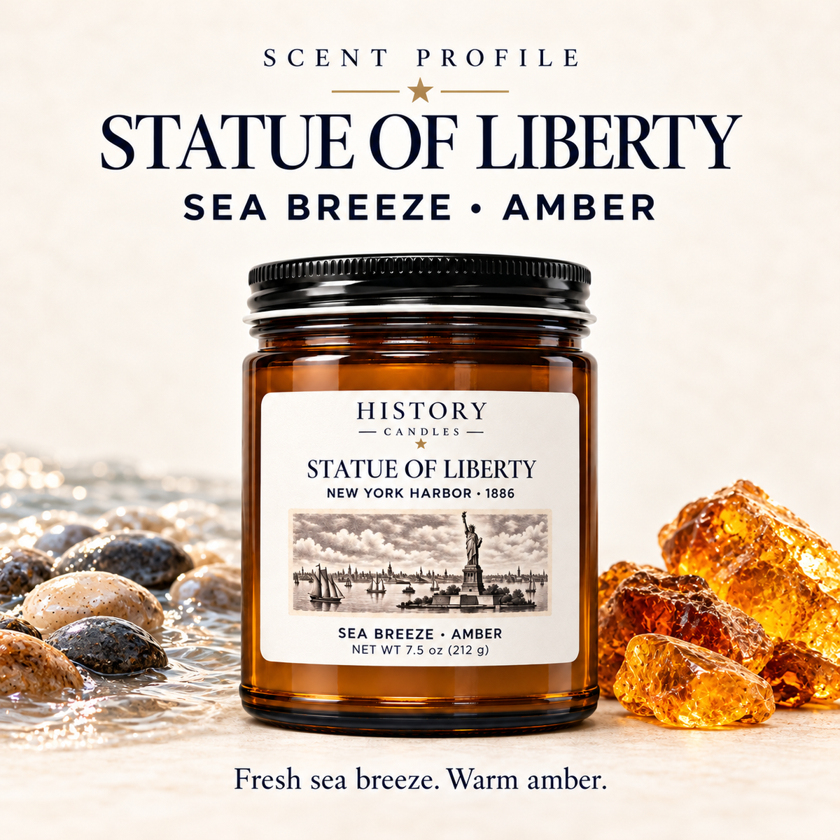 Statue of Liberty scent profile: fresh sea breeze and warm amber, illustrated with coastal stones and amber beside the candle.