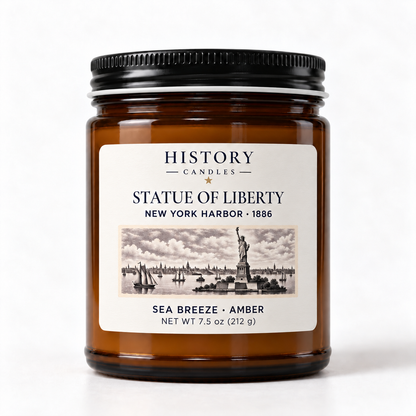 Statue of Liberty Sea Breeze · Amber candle in an amber glass jar with a black lid and illustrated New York Harbor label.